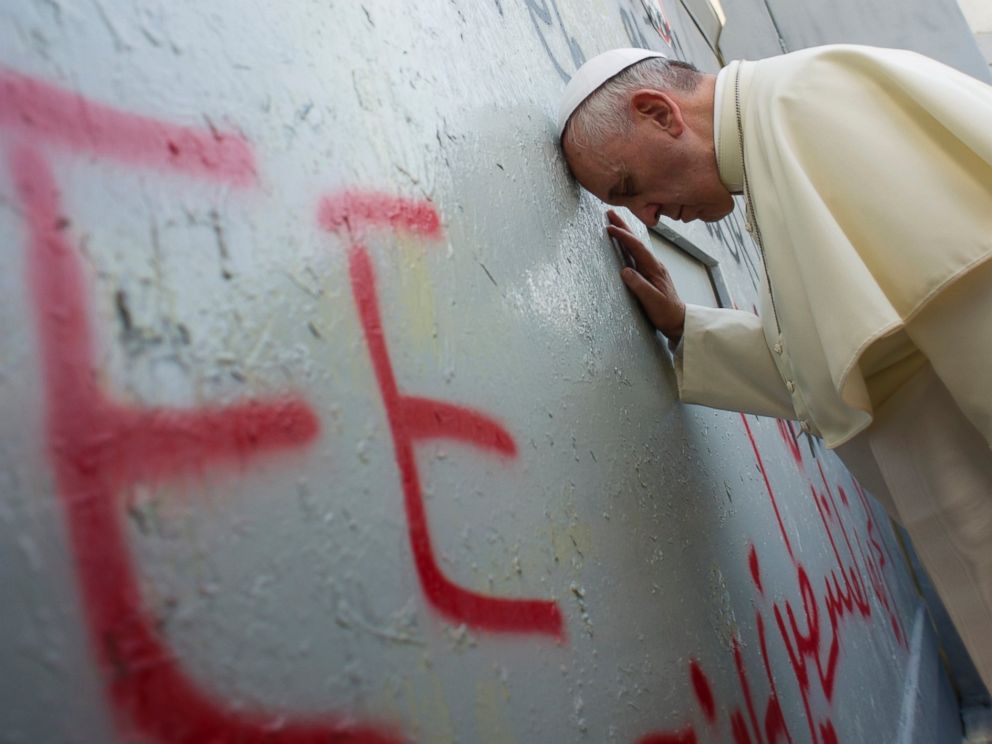 PHOTO: Pope Francis touches the wall that divides Israel from the West Bank, on his way to celebrate a mass in Manger Square next to the Church of the Nativity in the West Bank town of Bethlehem, Sunday, May 25, 2014.