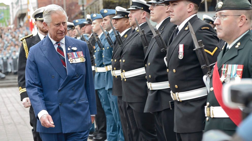 PHOTO: Prince Charles walks past guards n Halifax, Nova Scotia, May 19, 2014, during his trip to Canada with wife Camilla, the Duchess of Cornwall.