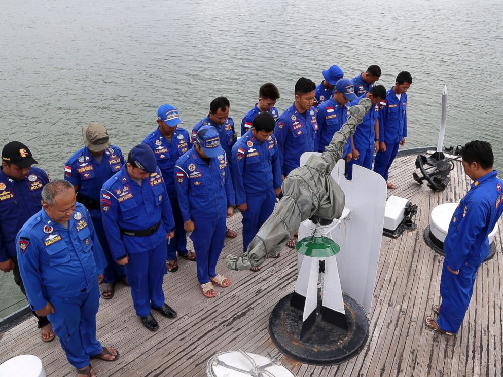 PHOTO: Members of Indonesias Marine Police pray on board a search and rescue ship before a search operation for the missing AirAsia flight 8501, at Pangkal Pinang port in Sumatra Island, Dec. 29, 2014 in Indonesia.