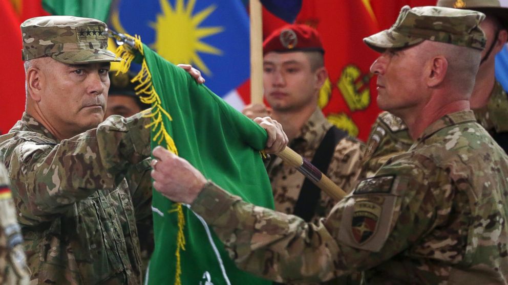 PHOTO: Commander of the International Security Assistance Force (ISAF), Gen. John Campbell, left, and Command Sgt. Maj. Delbert Byers open the "Resolute Support" flag during a ceremony at the ISAF headquarters in Kabul, Afghanistan, Dec. 28, 2014. 