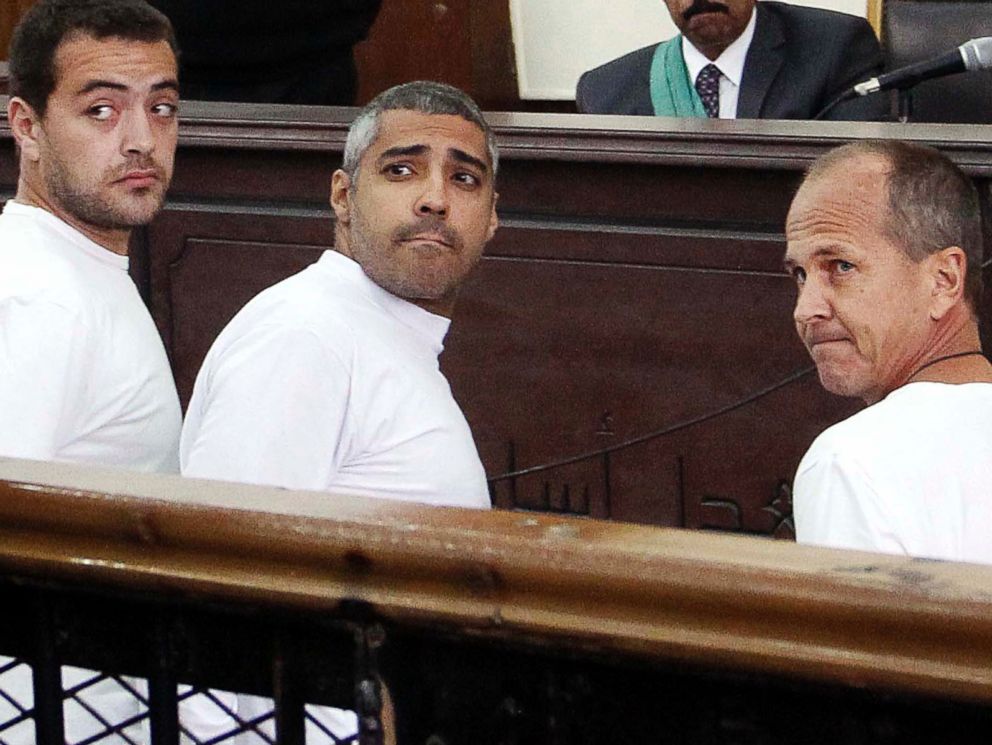 PHOTO: Al-Jazeera English producer Baher Mohamed, left, Canadian-Egyptian acting Cairo bureau chief Mohammed Fahmy, center, and correspondent Peter Greste, right, appear in court along with several other defendants, in Cairo, Egypt, March 31, 2014.