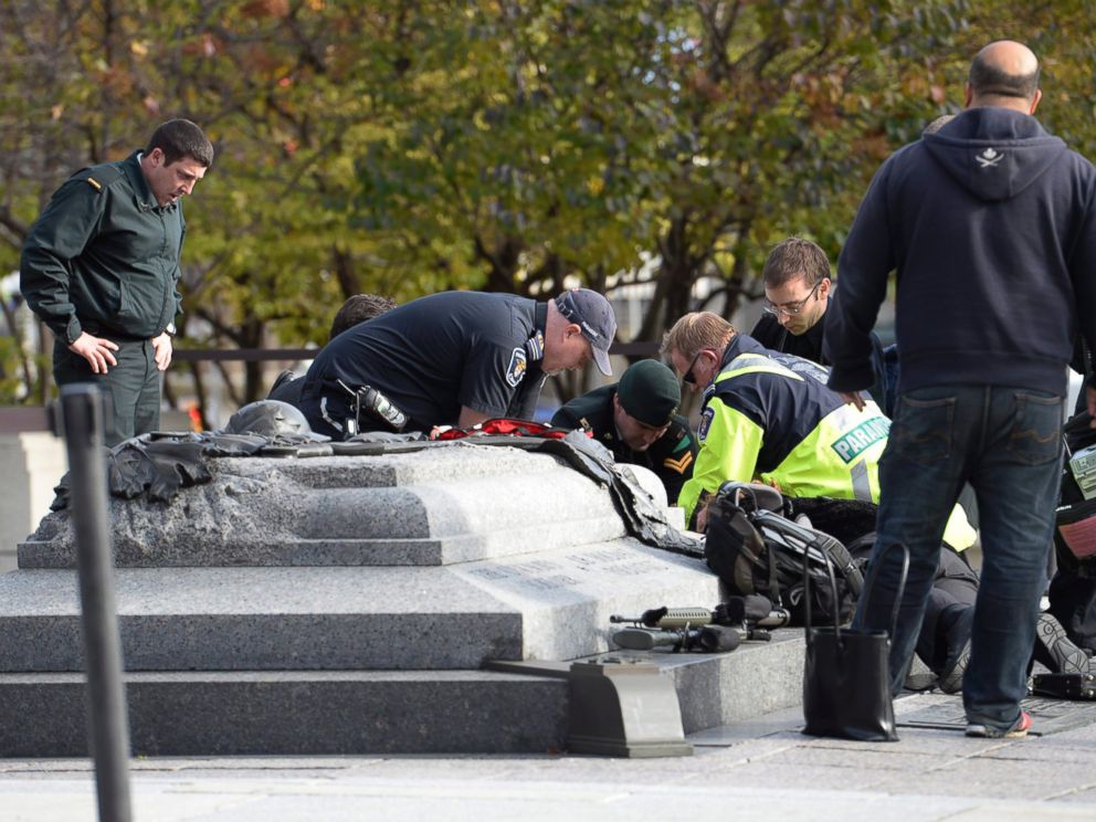 PHOTO: Emergency personnel tend to a soldier shot at the National Memorial near Parliament Hill in Ottawa, Oct. 22, 2014.