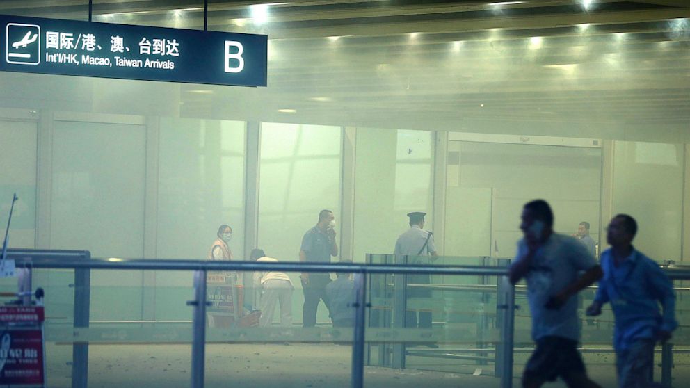 PHOTO: In this photo released by Chinas Xinhua News Agency, medical workers and policemen work at the terminal 3 of the Beijing International Airport in Beijing, Saturday, July 20, 2013.
