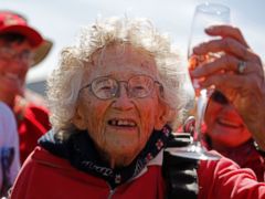 PHOTO: Centenarian Georgina Harwood, celebrates after her tandem parachute jump forming part of her birthday celebrations, in Cape Town, South Africa, Saturday, March 14, 2015.