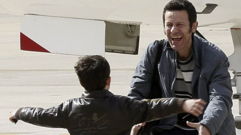 PHOTO: Spanish reporter Javier Espinosa, reacts as his son Yerai runs towards him upon his arrival at the military airport of Torrejon in Madrid, Sunday, March 30, 2014.