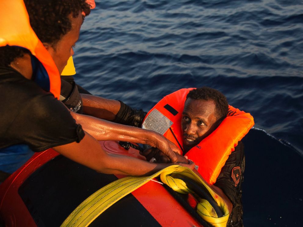 PHOTO: A migrant from Eritrea is helped after jumping into the water from a crowded wooden boat during a rescue operation in the Mediterranean sea, Aug. 29, 2016.