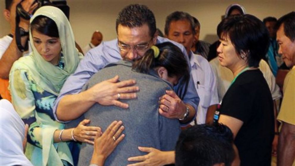 PHOTO: Malaysias acting Transport Minister Hishammuddin Hussein, center, comforts a relative of passengers on board the missing Malaysia Airlines flight MH370 at a hotel in Putrajaya, Malaysia, Saturday March 29, 2014.