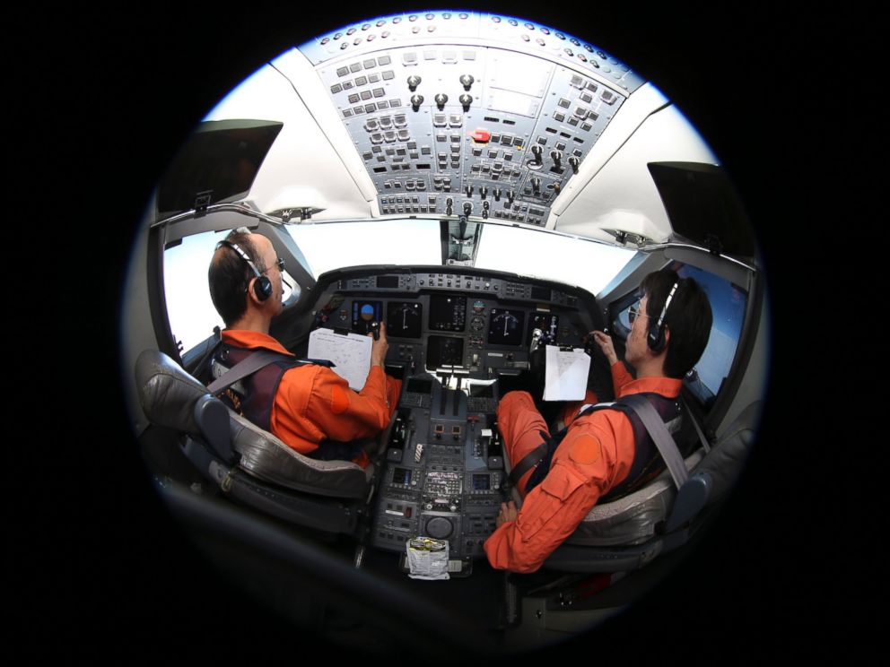 PHOTO: Captain of the Japan Coast Guard Gulfstream Makoto Hoshi, left, and his co-pilot Shunichi Yumiza sit in the cockpit during a search for the missing Malaysia Airlines Flight MH370 in the Southern Indian Ocean, near Australia, April 1, 2014.