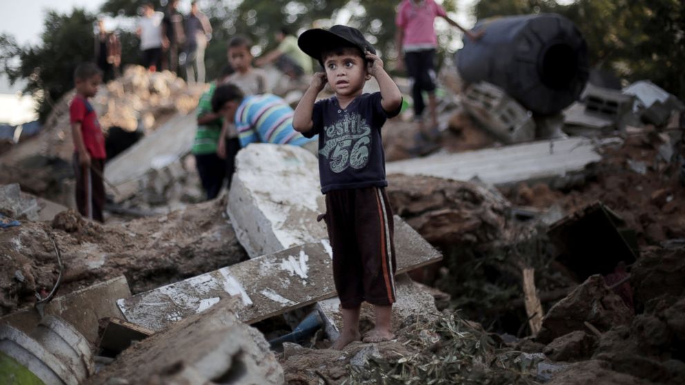 PHOTO: A Palestinian boy stands in the rubble of a destroyed house the day after an Israeli strike in the town of Beit Hanoun, Gaza Strip, July 9, 2014.