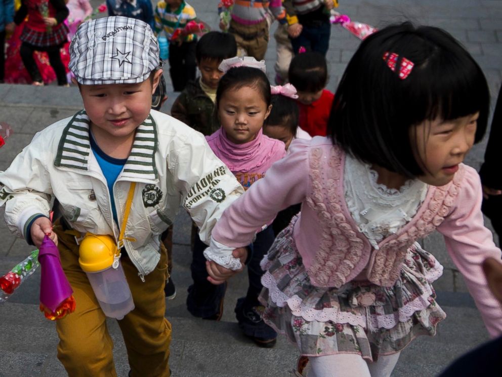 PHOTO: North Korean children climb steps near Mansu Hill on their way to lay flowers at the feet of bronze statues of the late North Korean leaders Kim Il Sung and Kim Jong Il in Pyongyang, North Korea on April 12, 2014.