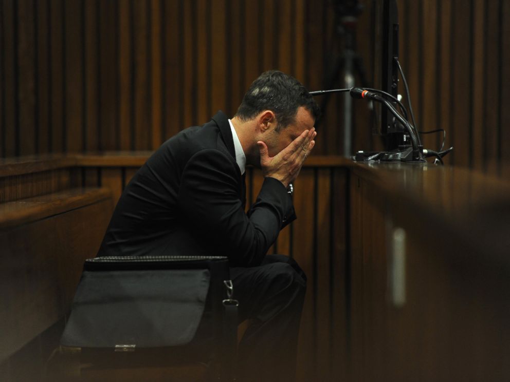 PHOTO: Oscar Pistorius listens to evidence from a witness speaking about the morning of the shooting of his girlfriend Reeva Steenkamp on the fourth day of his trial at the high court in Pretoria, South Africa, March 6, 2014.