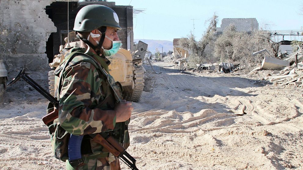 PHOTO: In this photo taken on a government organized media tour, a Syrian army soldier wears a medical mask as stand guard on a street in the Jobar neighborhood of Damascus, Syria, Saturday, Aug. 24, 2013.