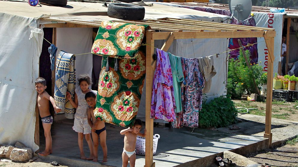 PHOTO: Syrian refugee children stand outside their tent at a temporary refugee camp in the eastern Lebanese town of Faour near the border with Syria, Lebanon, Aug. 28, 2013.