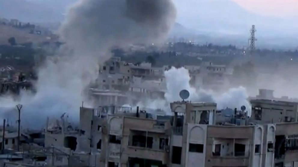 In this image taken from video obtained from the Shaam News Network, which has been authenticated based on its contents and other AP reporting, smoke rises from buildings due to heavy artillery shelling in Barzeh, a district of Damascus, Syria, Sept. 10, 2013. 