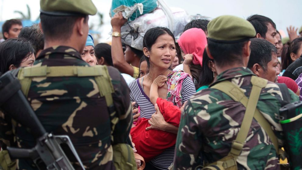 PHOTO: A woman breaks into tears as she waits for their turn to ride a military plane to flee their typhoon-ravaged homes in Tacloban city, Leyte province, central Philippines, Nov. 12, 2013.