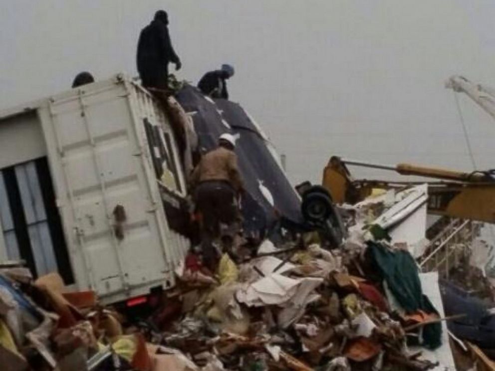 People inspect the wreckage following a jet crash near Grand Bahama International Airport in Freeport, Bahamas, Nov. 9, 2014.