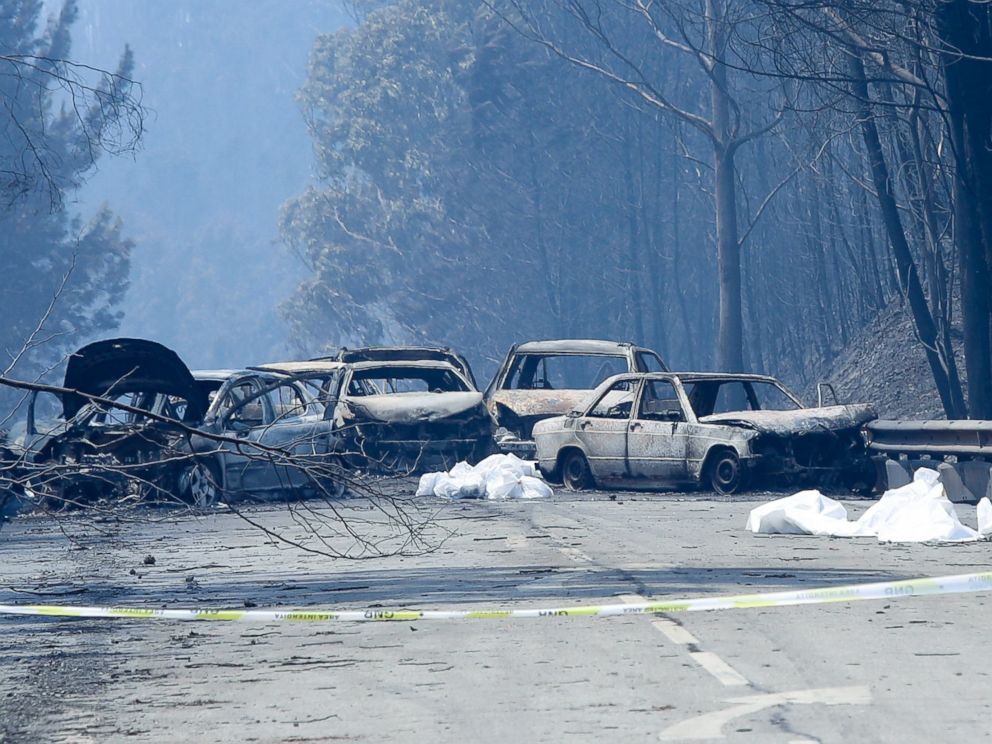 PHOTO: Burnt cars and body bags are seen on the N236 road between Figueiro dos Vinhos and Castanheira de Pera, near Pedrogao Grande, central Portugal, June 18, 2017.