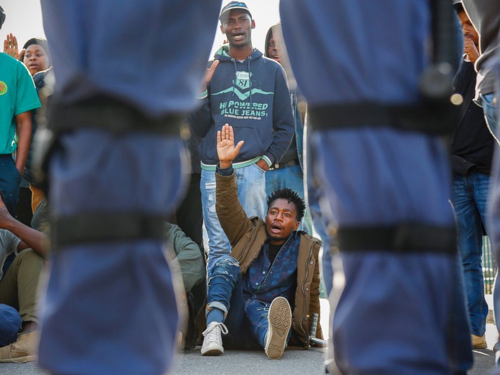 PHOTO: South Africans face police as they protest in support of the #BlackLivesMatter movement outside the US embassy in Cape Town, South Africa, July 13, 2016.