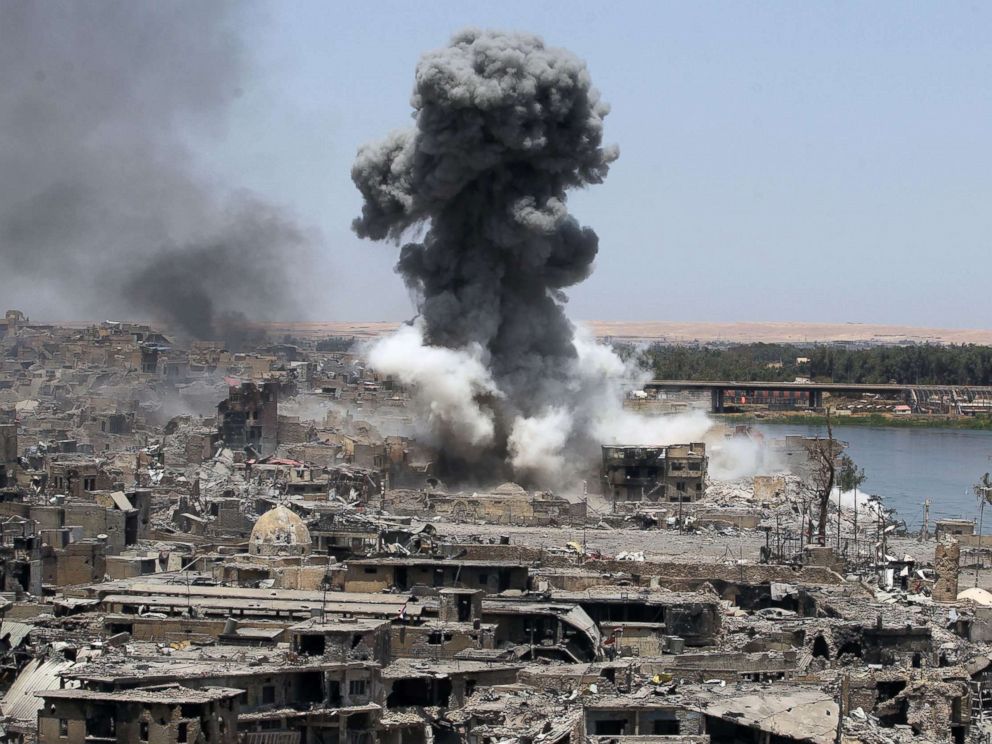 PHOTO: A picture taken on July 9, 2017, shows smoke billowing following an airstrike by US-led international coalition forces targeting Islamic State (IS) group in Mosul.