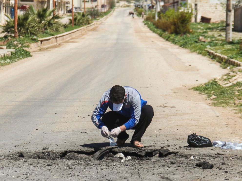 PHOTO:A Syrian man collects samples from the site of a suspected toxic gas attack in Khan Sheikhun, in Syrias Idlib province, April 5, 2017.