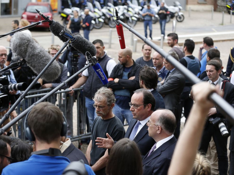 PHOTO: French President Francois Hollande speaks to the press as he leaves the Saint-Etienne-du-Rouvrays city hall following a hostage-taking at a church of the town on July 26, 2016 that left the priest dead. 
