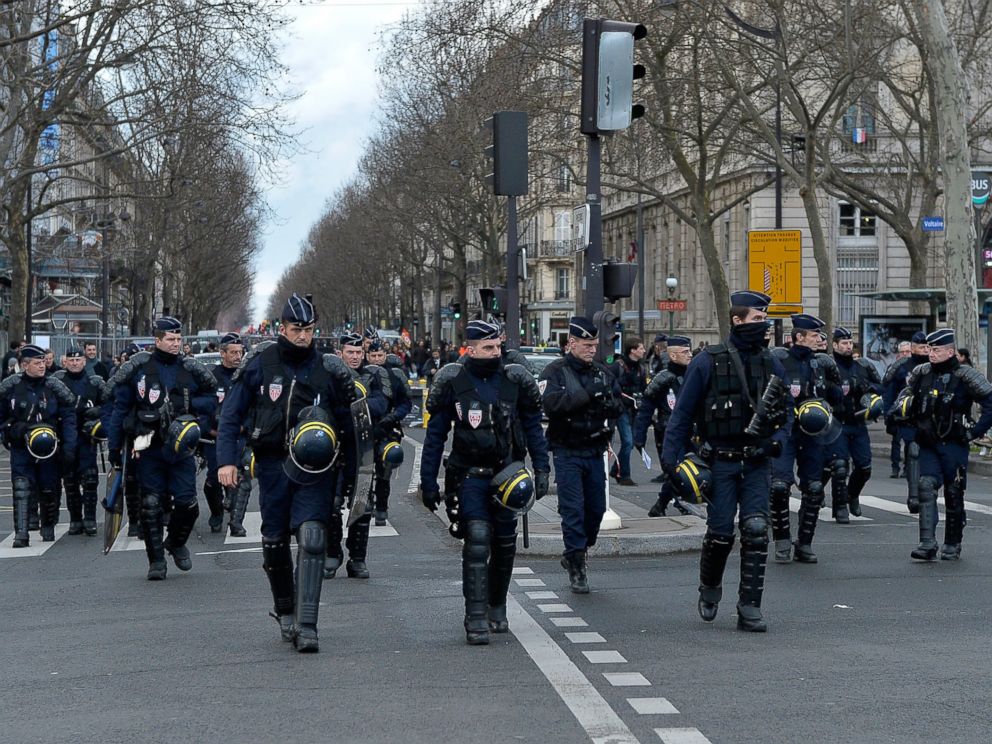 PHOTO: French riot police walk in front of protestors during the demonstration against labour reforms on March 9, 2016 in Paris, France.