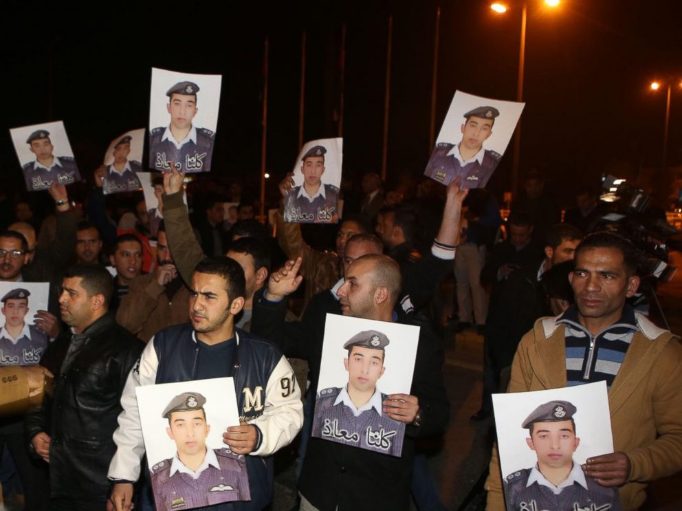 PHOTO: Protestors carry pictures of Muath al-Kaseasbeh, Jordanian pilot who crashed in Syria, at a protest near the Jordanian Prime Minister office in Amman, Jordan, Jan. 27, 2015.