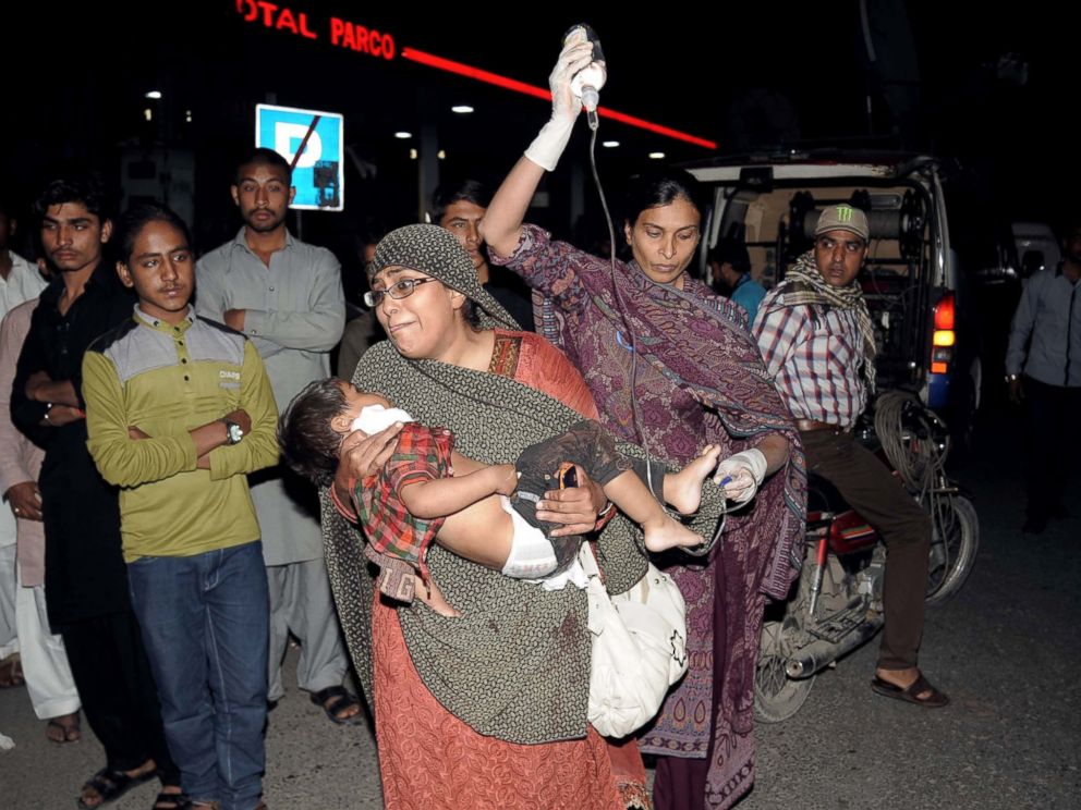 PHOTO: Pakistani relatives bring an injured child to the hospital in Lahore, on March 27, 2016, when an apparent suicide bomb ripped through the parking lot of a crowded park in the Pakistani city of Lahore where Christians were celebrating Easter.