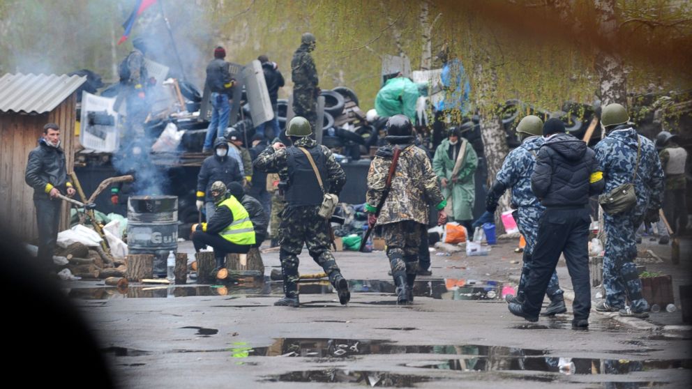 PHOTO: Pro-Russia protesters guard a barricade outside a regional police building seized by armed separatists in Slavyansk, April 13, 2014.