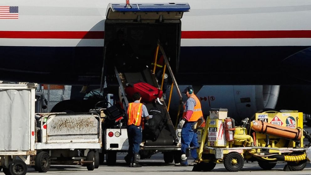 PHOTO: Airline workers load luggage and cargo into a US Airways passenger plane at Los Angeles International Airport on Oct. 30, 2010 in Los Angeles, Calif.
