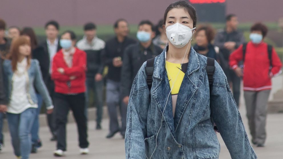 PHOTO: People visit Tiananmen Square, blanketed in smog, March 27, 2014 in Beijing, China.
