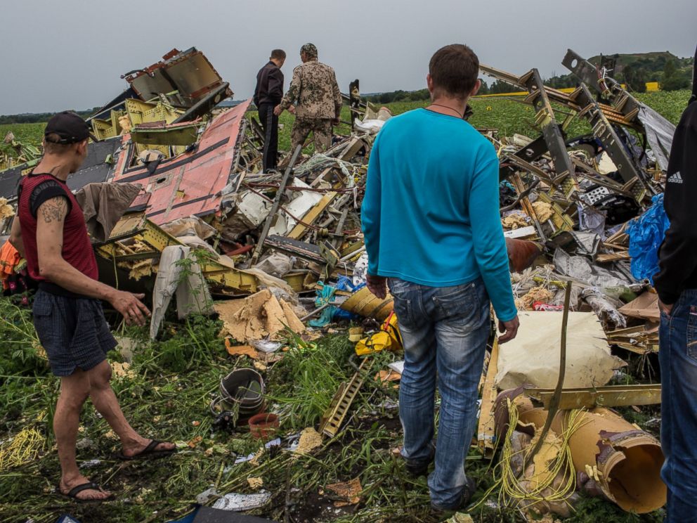 PHOTO: A group of people are pictured looking at the wreckage of Malaysia Airlines Flight 17 on July 18, 2014 in Grabovka, Ukraine.