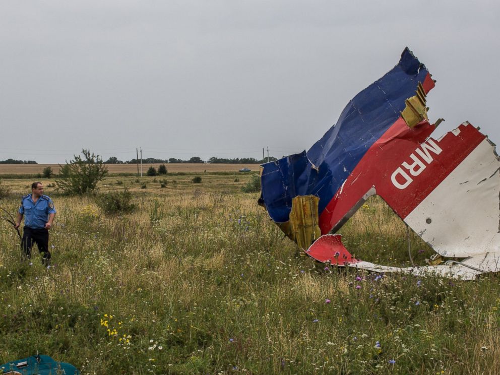 PHOTO: A Ukrainian police officer searches for human remains from Malaysia Airlines Flight 17 on July 18, 2014 in Grabovka, Ukraine.
<p itemprop=