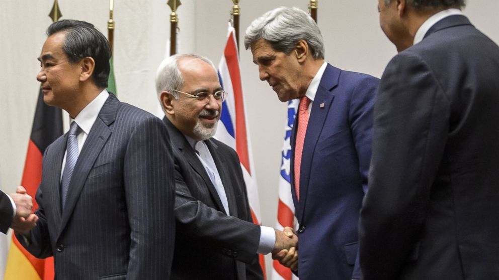 PHOTO: Iranian Foreign Minister Mohammad Javad Zarif (2nd L) shakes hands with U.S. Secretary of State John Kerry after a statement on early Nov. 24, 2013 in Geneva.