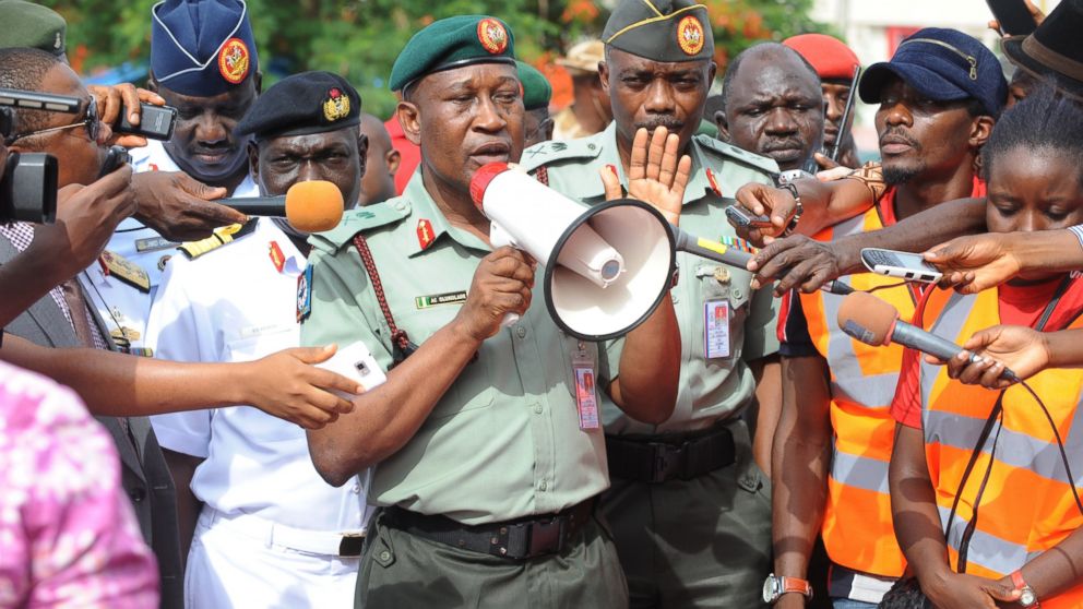 PHOTO: Nigerian Defense spokesman Major General Chris Olukolade, center, speaks to civil society groups protesting the abduction of hundreds of girls during a rally pressing for the girls release in Abuja, May 6, 2014.