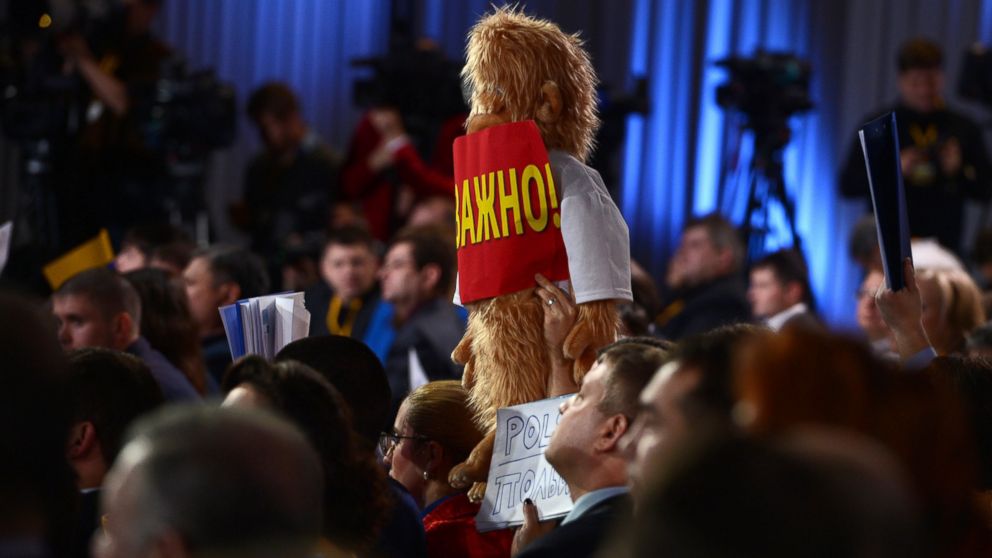 PHOTO: A journalist raises up a plush toy for questions at a press conference