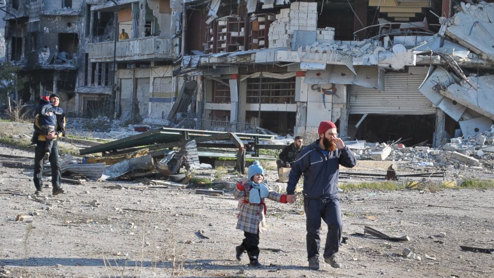 PHOTO: Civilians walk towards an evacuation point in the besieged Syrian city of Homs ahead of an evacuation operation led by the UN, on Feb. 9, 2014.