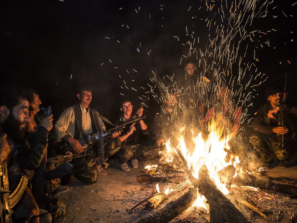 PHOTO: Turkmen soldiers gather around fire at night in the Bayirbucak region in Syria, Oct. 27, 2015.