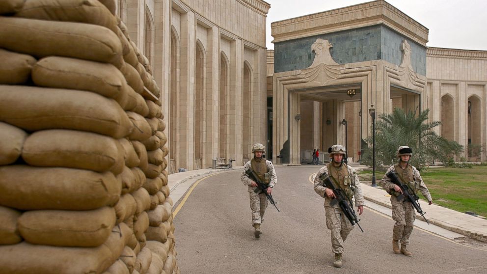 PHOTO: U.S. Marines walk past the front of the American Embassy, Feb. 6, 2007, in Baghdad, Iraq.