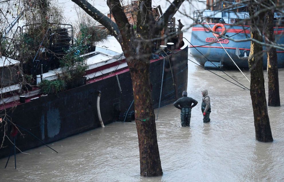PHOTO: Paris shows People stand in flood water along the banks of the Seine river in Paris, Jan. 22, 2018.