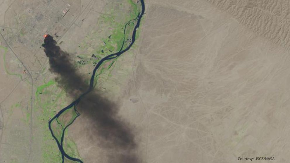 PHOTO: This photo from the U.S. Geological Survey and NASA shows a satellite view of smoke billowing from the Baiji North refinery complex on June 18, 2014 in Baiji, about 130 miles north of Baghdad, Iraq. 