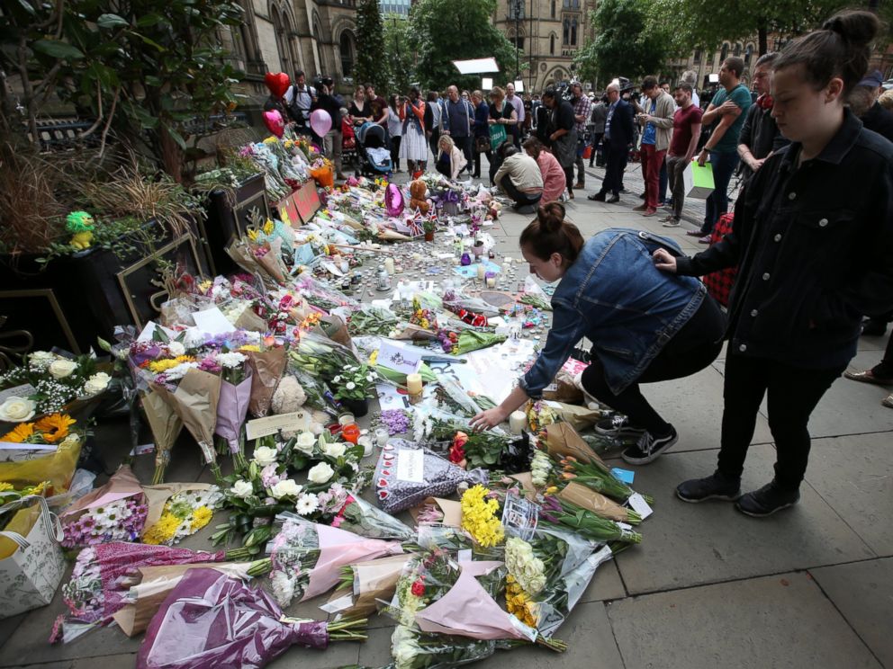PHOTO: People at Albert Square in Manchester, UK look at the growing amount of floral tributes for the victims of the Manchester terror attack.