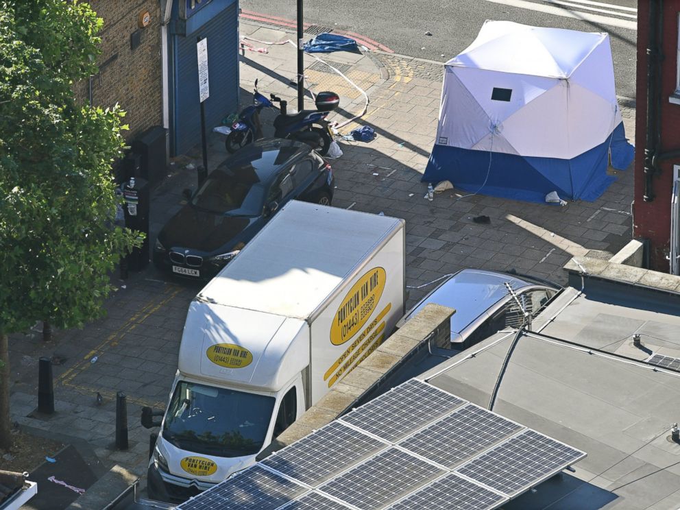PHOTO: British forensic experts stand next to the van and a forensic tent in Finsbury Park, after a van hit worshipers in north London, June 19, 2017.