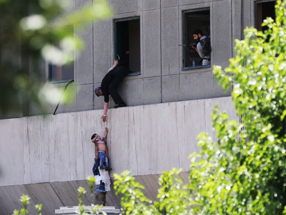 PHOTO: A boy is evacuated during an attack on the Iranian parliament in central Tehran, Iran, June 7, 2017.