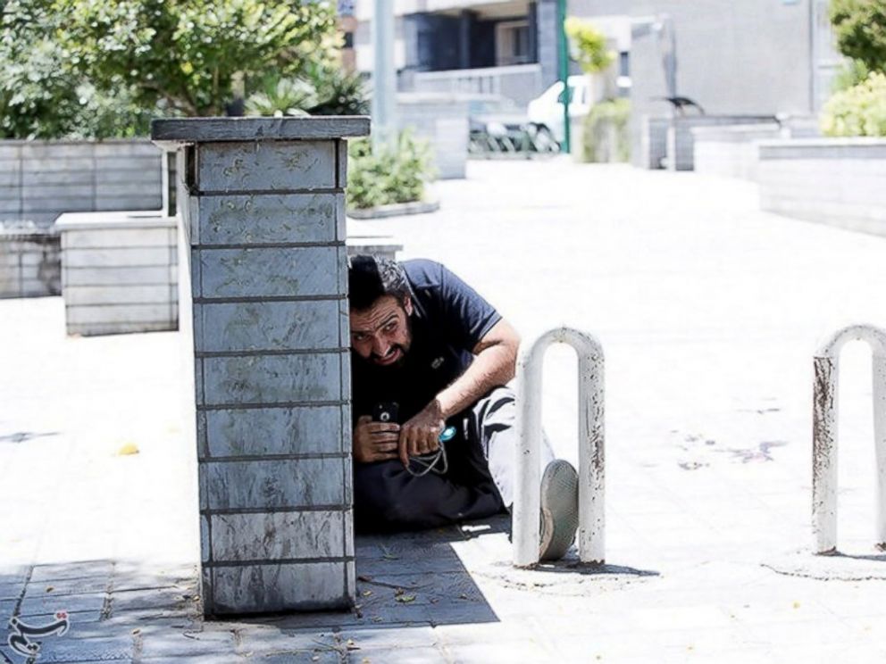 PHOTO: A man takes cover during an attack on the Iranian parliament in central Tehran, Iran, June 7, 2017.