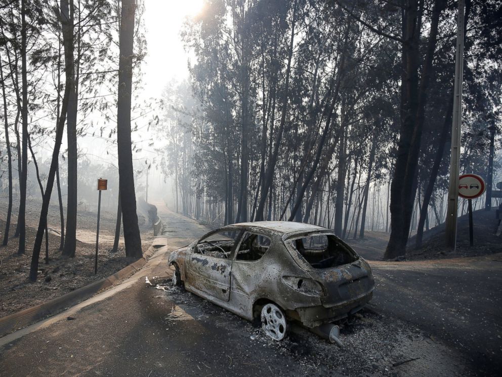 PHOTO: A burned car is seen in the aftermath of a forest fire near Pedrogao Grande, in central Portugal, June 18, 2017.
