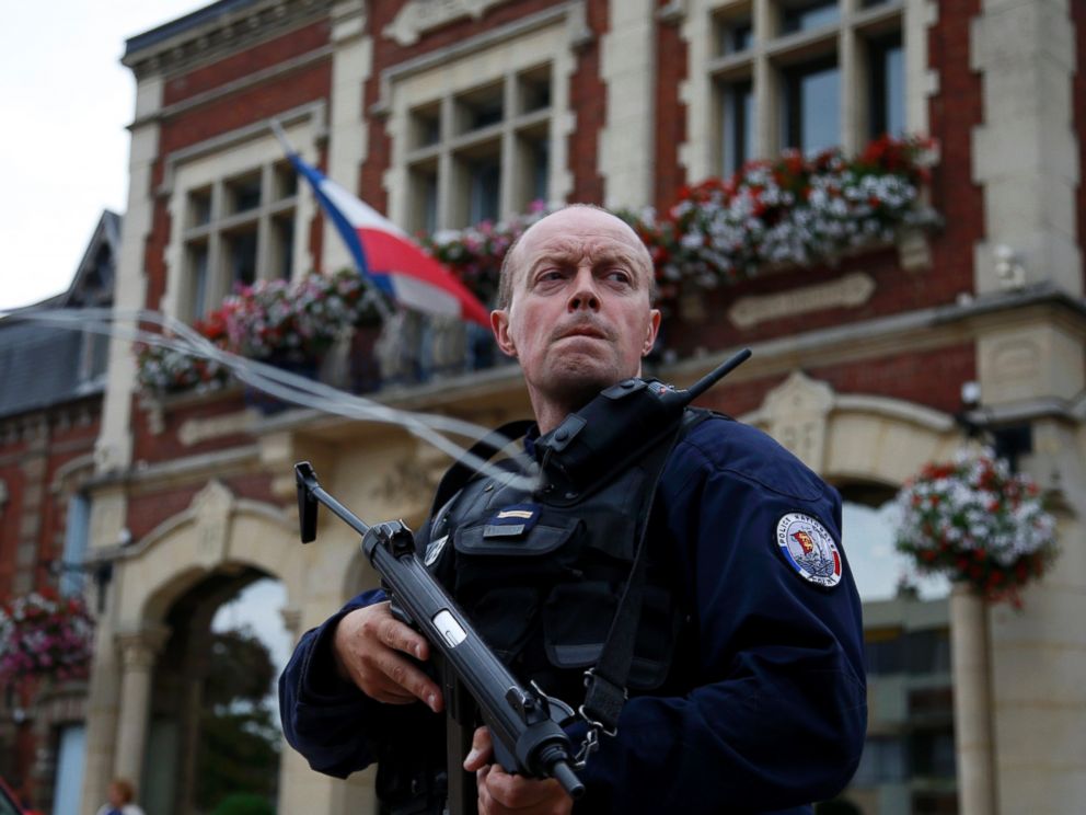 PHOTO: A policeman secures a position in front of the city hall after two assailants had taken five people hostage in the church at Saint-Etienne-du-Rouvray near Rouen in Normandy, France, July 26, 2016. 