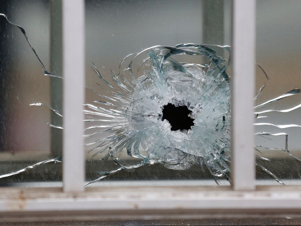 PHOTO: A bullets impact is seen on a window at the scene after a shooting at the Paris offices of Charlie Hebdo, a satirical newspaper, Jan. 7, 2015. 