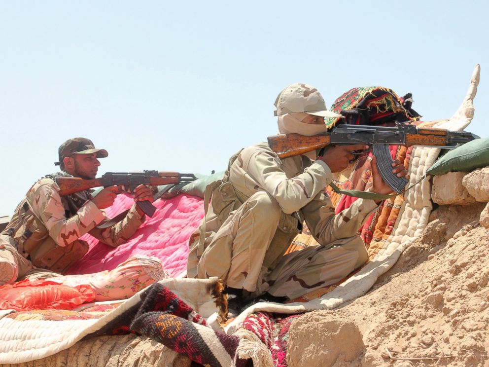 PHOTO: Iraqi security forces and volunteers take part in a mission to secure an area