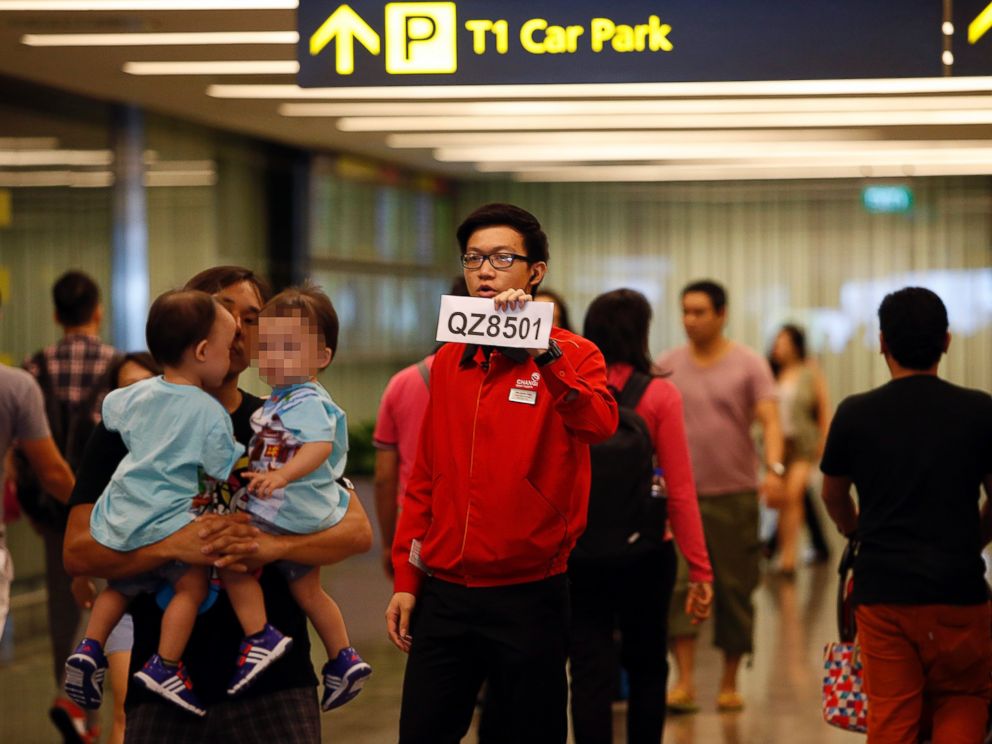 PHOTO: A Changi Airport staff member holds up a sign to direct possible next-of-kins of passengers of AirAsia flight QZ 8501 from the Indonesian city of Surabaya to Singapore, at Changi Airport in Singapore, Dec. 28, 2014. 